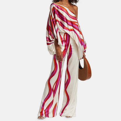 Tvådelat set dam med off-shoulder topp och vida byxor